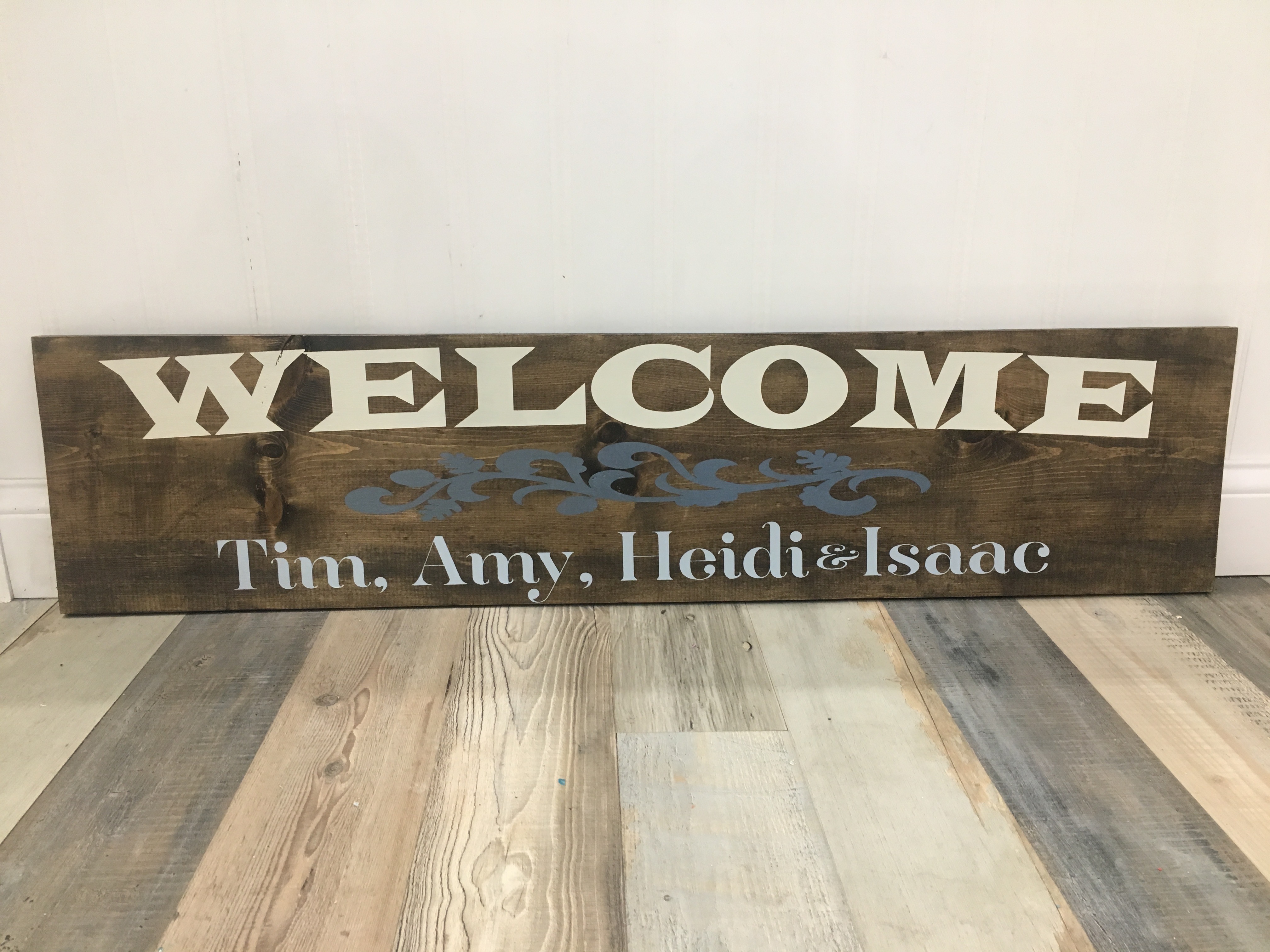 welcome sign with names on wooden sign