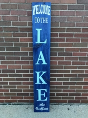 welcome to the lake blue wood sign