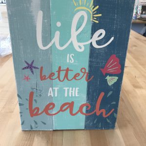 life is better at the beach on wood paneling