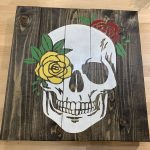 wood sign with skull and flowers