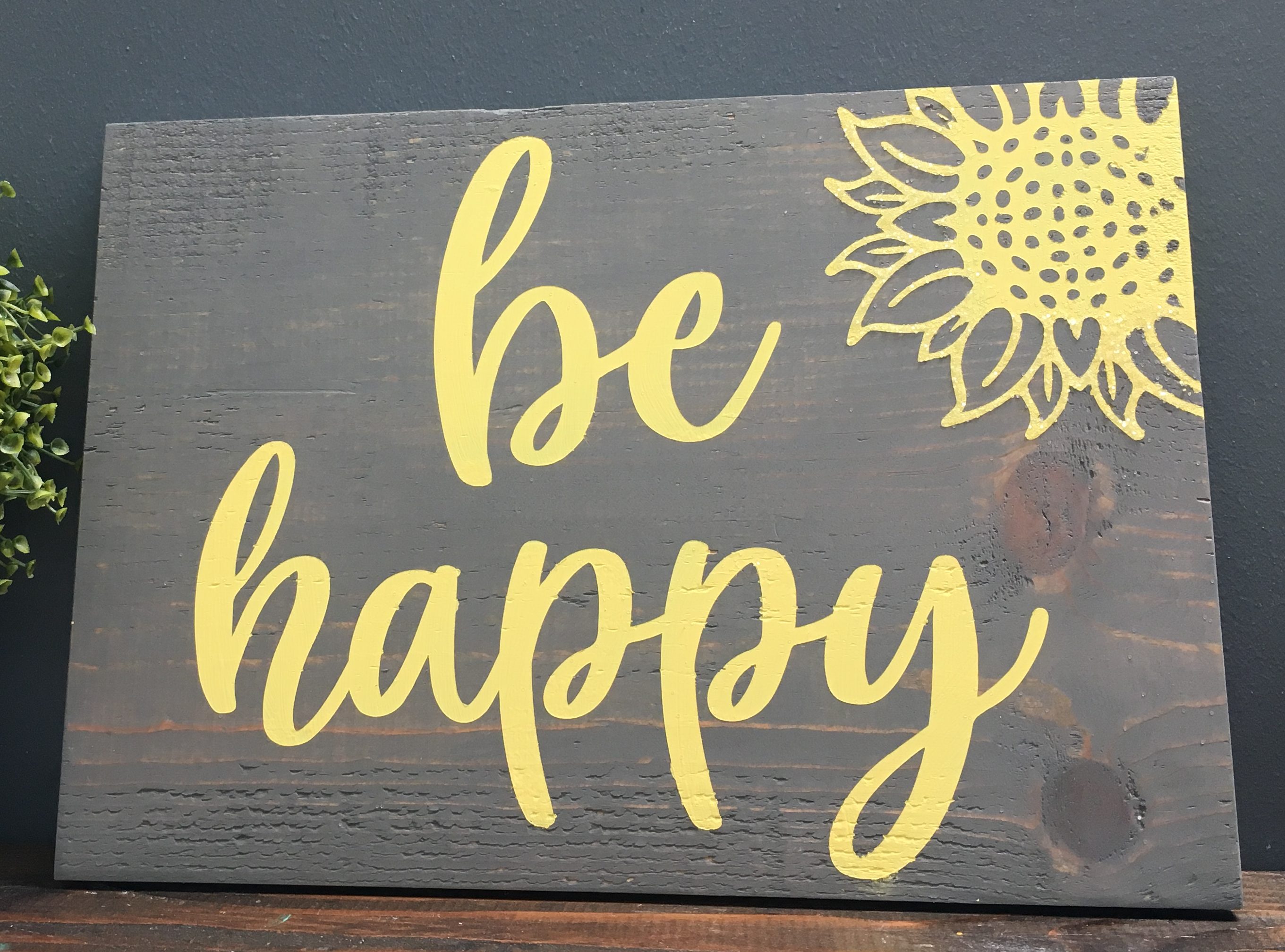 Wood sign that says be happy